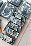 Nature's Natural Lather Vegan Lemongrass & Patchouli Soap Bar Perfect For Men & Oily Skin With An Unresistable Scent & Exfoliating Deep Cleansing Benefits Thanks To Activated Charcoal & Coconut Oil. From Black Owned Atlanta Based Vegan Organic Handcrafted Bath & Body Care Company. Palm Oil Free & Phthalate Free With Sustainable Ingredients.