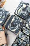 Nature's Natural Lather Vegan Lemongrass & Patchouli Soap Bar Perfect For Men & Oily Skin With An Unresistable Scent & Exfoliating Deep Cleansing Benefits Thanks To Activated Charcoal & Coconut Oil. From Black Owned Atlanta Based Vegan Organic Handcrafted Bath & Body Care Company. Palm Oil Free & Phthalate Free With Sustainable Ingredients.